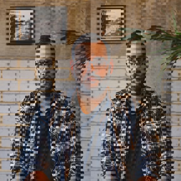 Man with glasses looking at the camera