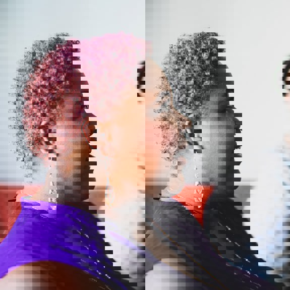 Woman with purple hair smiling