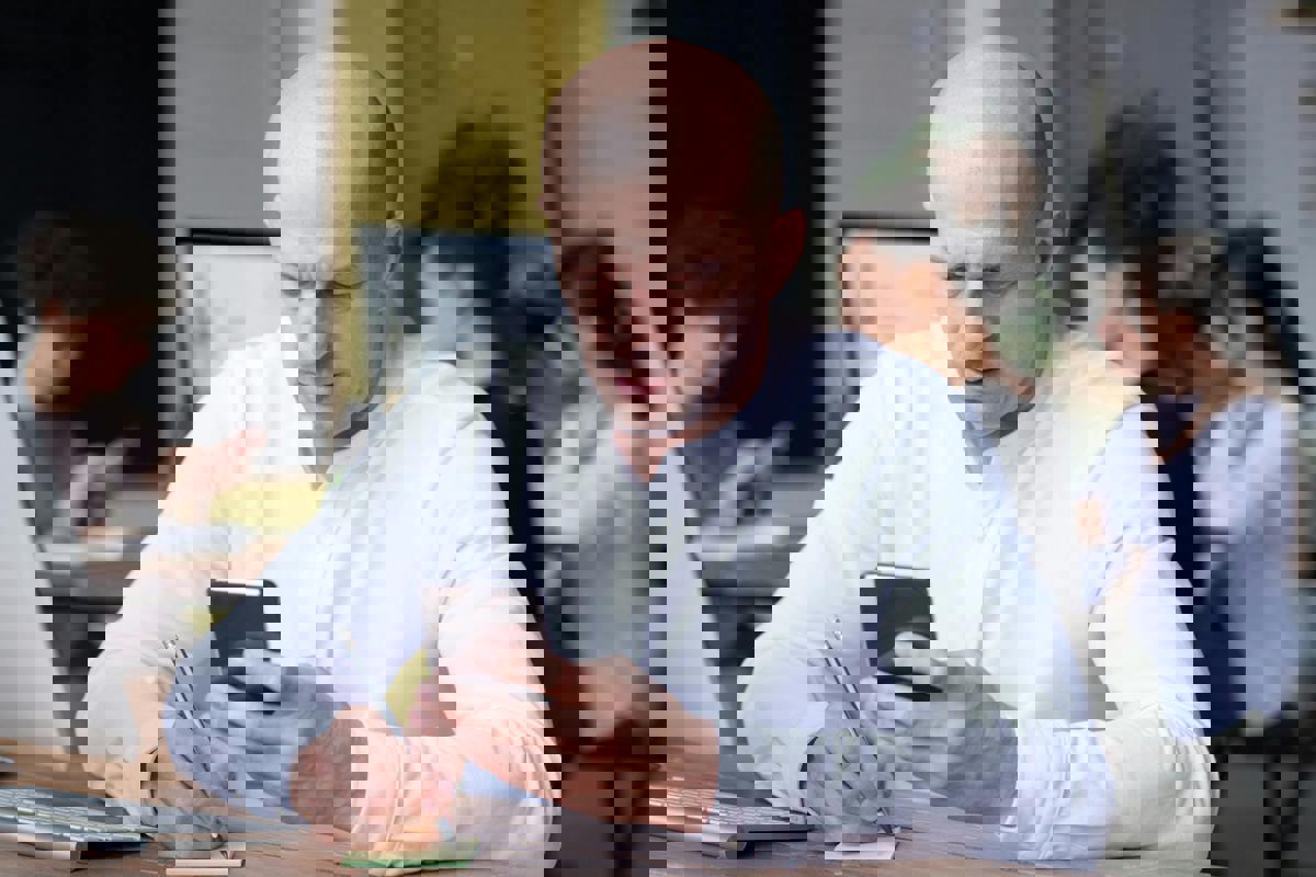 picture of man at desk on phone